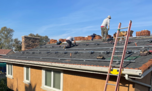 Workers installing solar panels on a residential roof, showcasing Suncovia’s expert solar installation services.