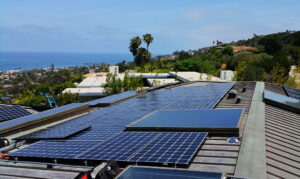Rooftop solar panel installation overlooking the coast, provided by Suncovia. Expert solar solutions for energy efficiency and sustainability.