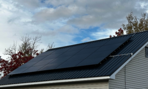 Suncovia solar panel installation on a metal roof, maximizing energy efficiency with sleek black panels.