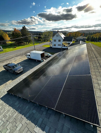 Rooftop solar installation in fall on a Maine home with clear skies