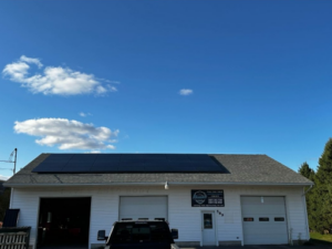 Suncovia commercial solar panel installation on a white garage building, maximizing renewable energy efficiency.