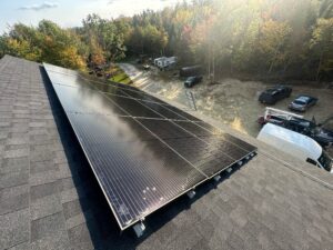 Rooftop solar panels installed by Suncovia in a scenic wooded area, providing sustainable and efficient energy solutions for off-grid living.