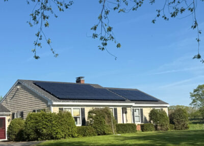House in Maine with solar panels, protecting homeowners from the Maine electricity rates increase and saving on energy costs.