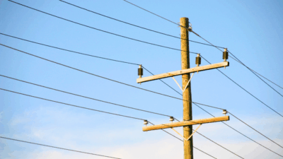 High-voltage power lines delivering electricity across Maine, highlighting concerns over CMP rate hikes