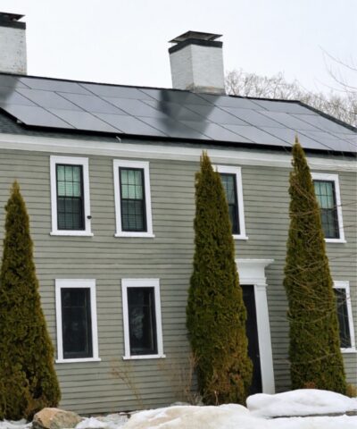 Rooftop solar panels on a Massachusetts home showing how homeowners can go solar in Massachusetts to save on electricity.