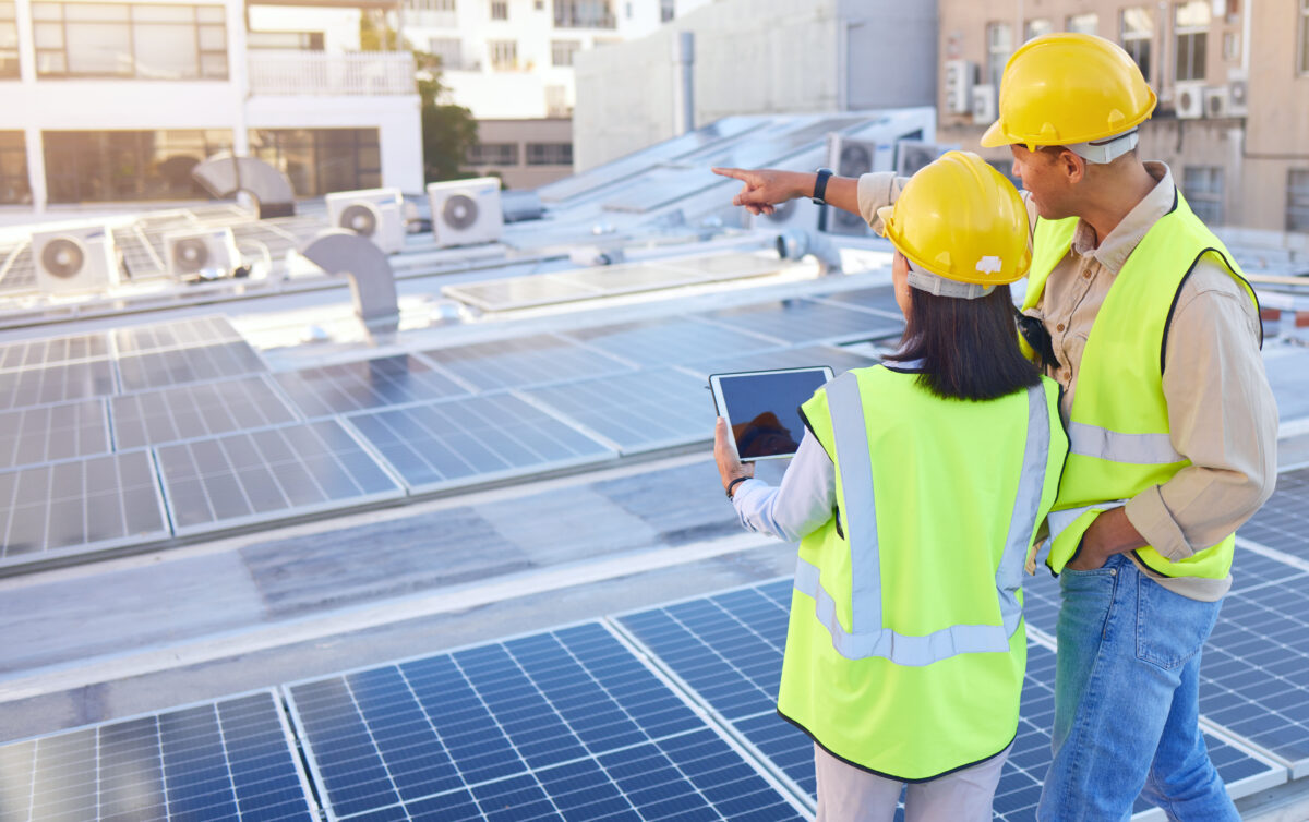 Engineer, back or woman with man, solar energy or sustainable power inspection. Technician, male or female for panels maintenance, eco friendly construction or agriculture for alternative electricity