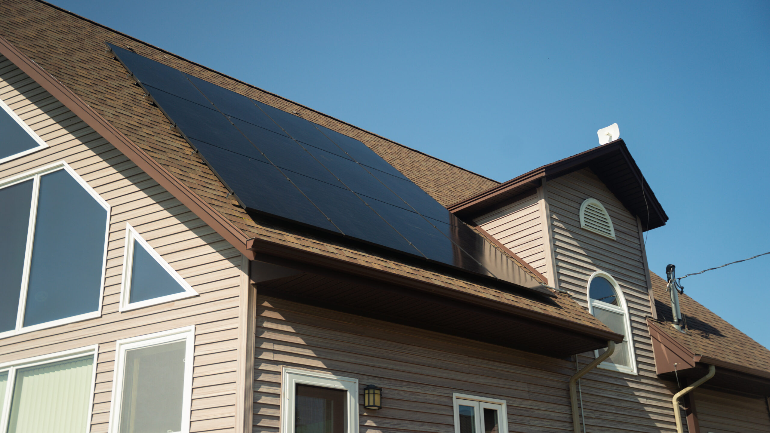 brown shingles roof and light pink siding