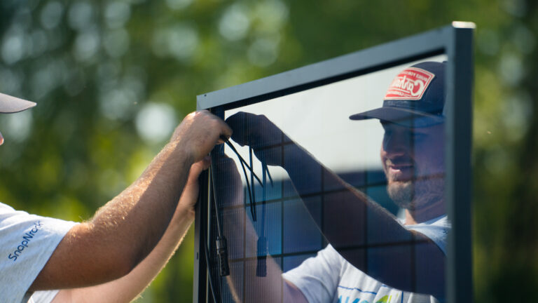 worker reflecting on solar panel