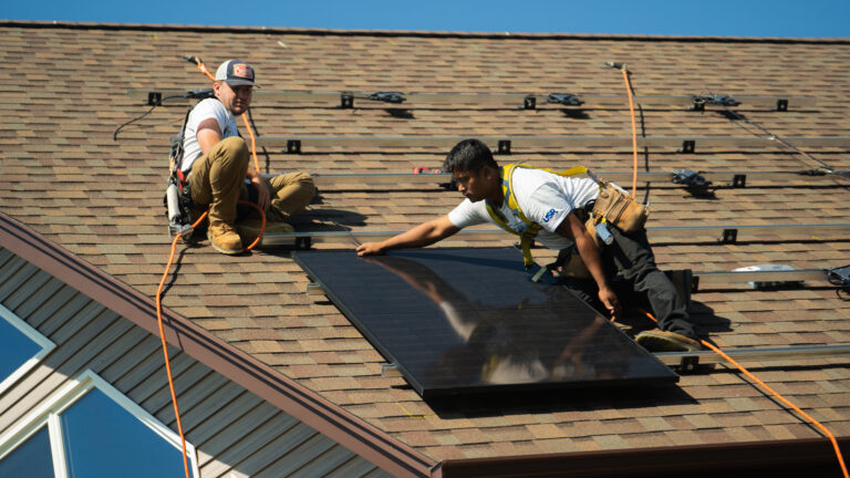 Suncovia workers on top of roof using ropes