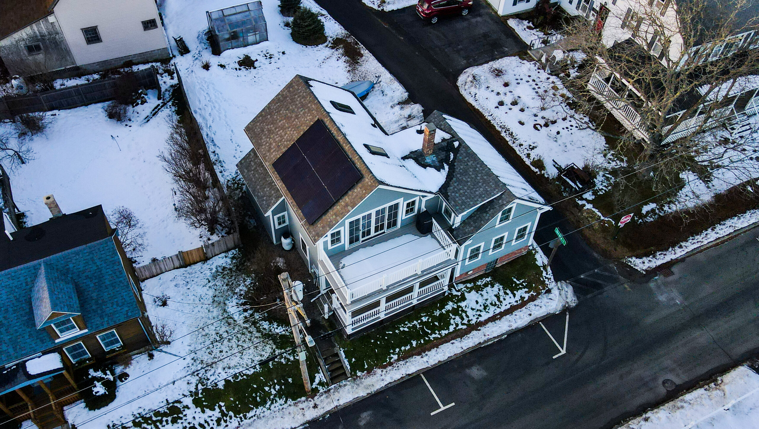 small house with solar panels during winter time