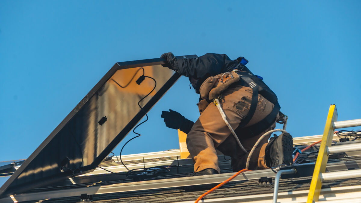 Suncovia worker installing new solar panels
